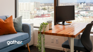 Private office space at Gather Workspaces featuring standing desk, modern furniture, natural light, and downtown city views.