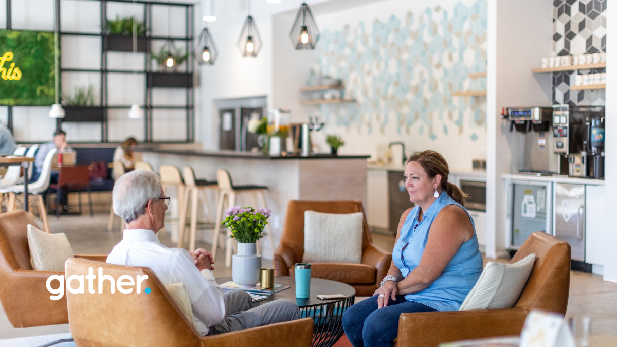Two people sitting and chatting in a shared coworking area at Gather Short Pump